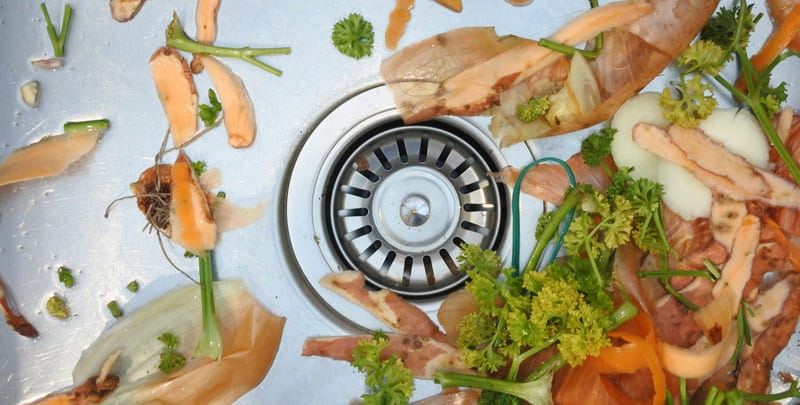 food scraps circling a kitchen sink drain